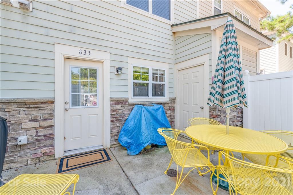 833 Millbrook Road, Unit 833 Charlotte, NC 28211 - Photo 21 of 23 a view of a chairs and table in the patio