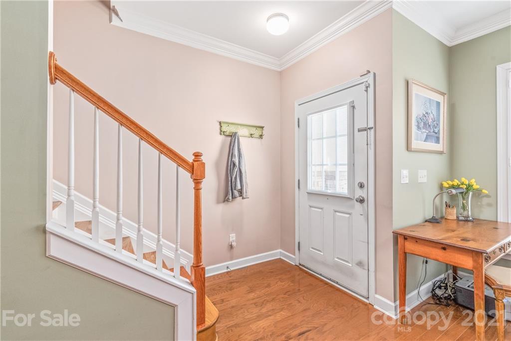 833 Millbrook Road, Unit 833 Charlotte, NC 28211 - Photo 6 of 23 a view of a hallway with wooden floor and staircase