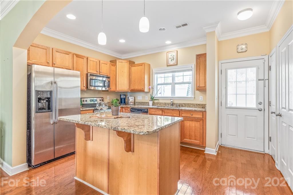 833 Millbrook Road, Unit 833 Charlotte, NC 28211 - Photo 7 of 23 a kitchen with stainless steel appliances granite countertop a refrigerator a sink and a stove