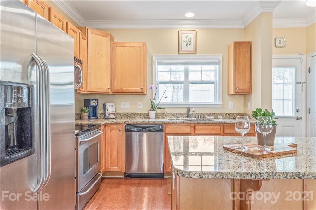 833 Millbrook Road, Unit 833 Charlotte, NC 28211 - Photo 9 of 23 a kitchen with stainless steel appliances granite countertop a stove a sink and a microwave