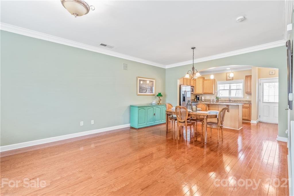 833 Millbrook Road, Unit 833 Charlotte, NC 28211 - Photo 10 of 23 a view of a dining room with furniture window and wooden floor