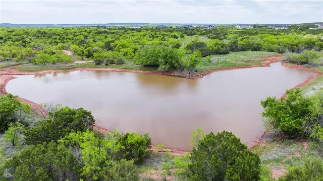 an aerial view of a houses with a lake view