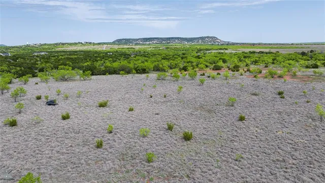 a view of a field with an ocean