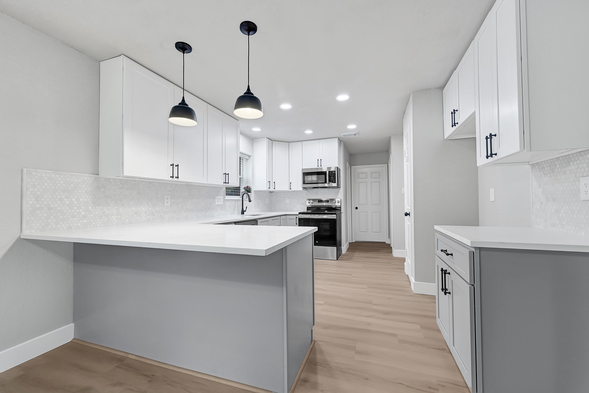 21211 Slippery Creek Lane Spring, TX 77388 - Photo 13 of 29 a large kitchen with stainless steel appliances kitchen island granite countertop a sink a stove and a refrigerator