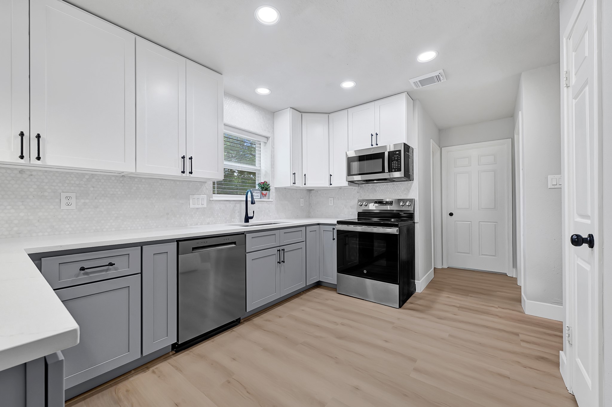 21211 Slippery Creek Lane Spring, TX 77388 - Photo 14 of 29 a kitchen with granite countertop white cabinets and stainless steel appliances