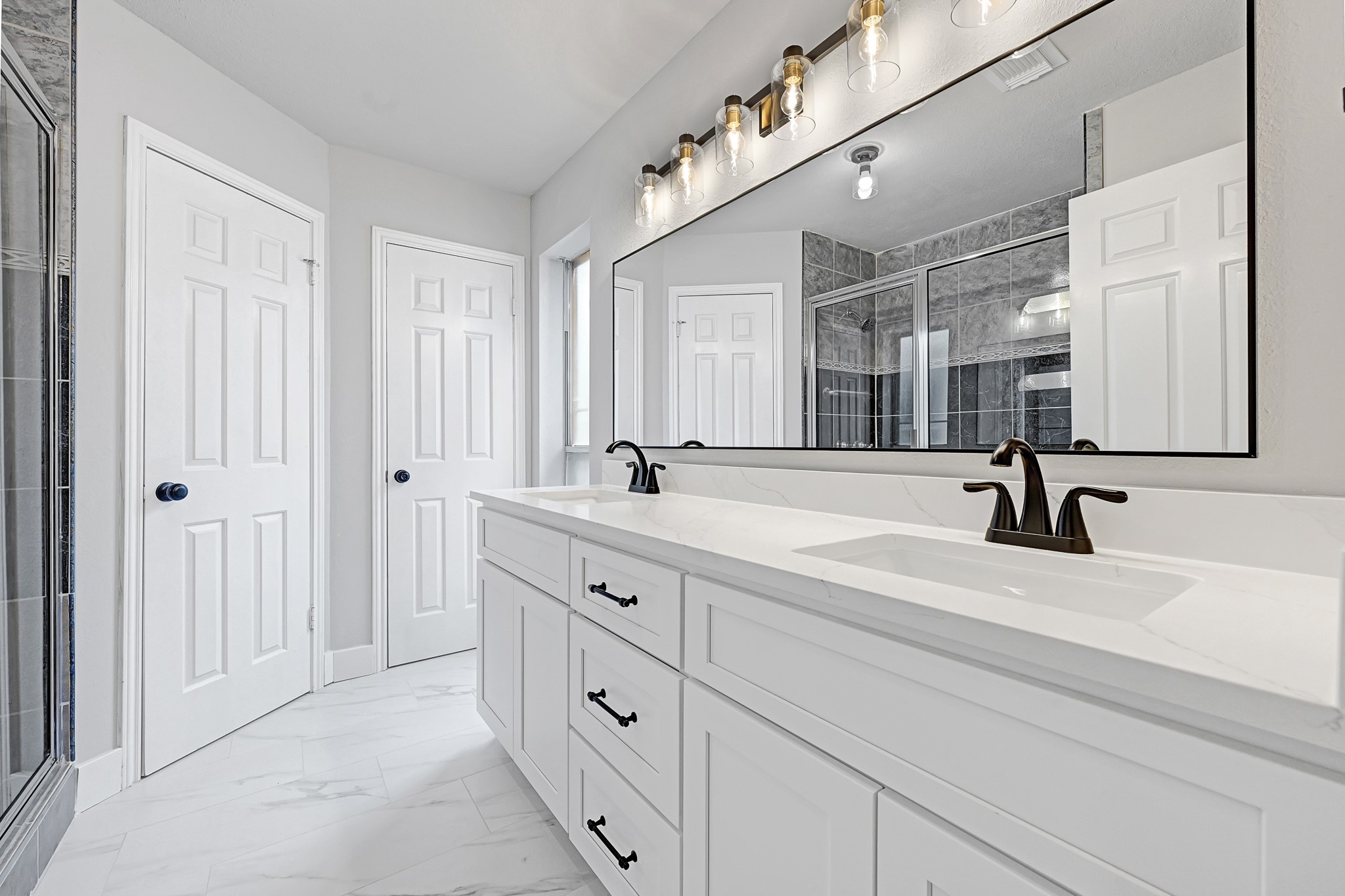 21211 Slippery Creek Lane Spring, TX 77388 - Photo 23 of 29 a bathroom with double sink and a mirror