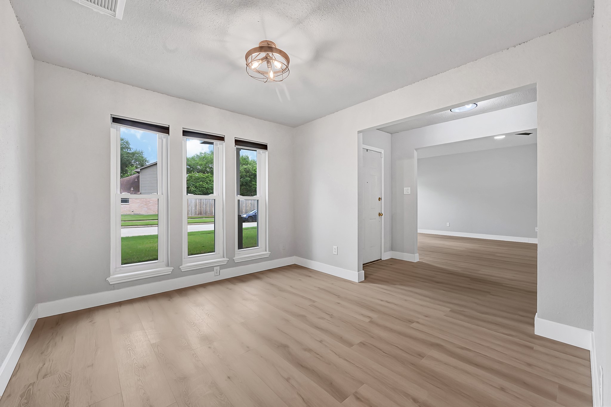 21211 Slippery Creek Lane Spring, TX 77388 - Photo 8 of 29 an empty room with wooden floor and windows