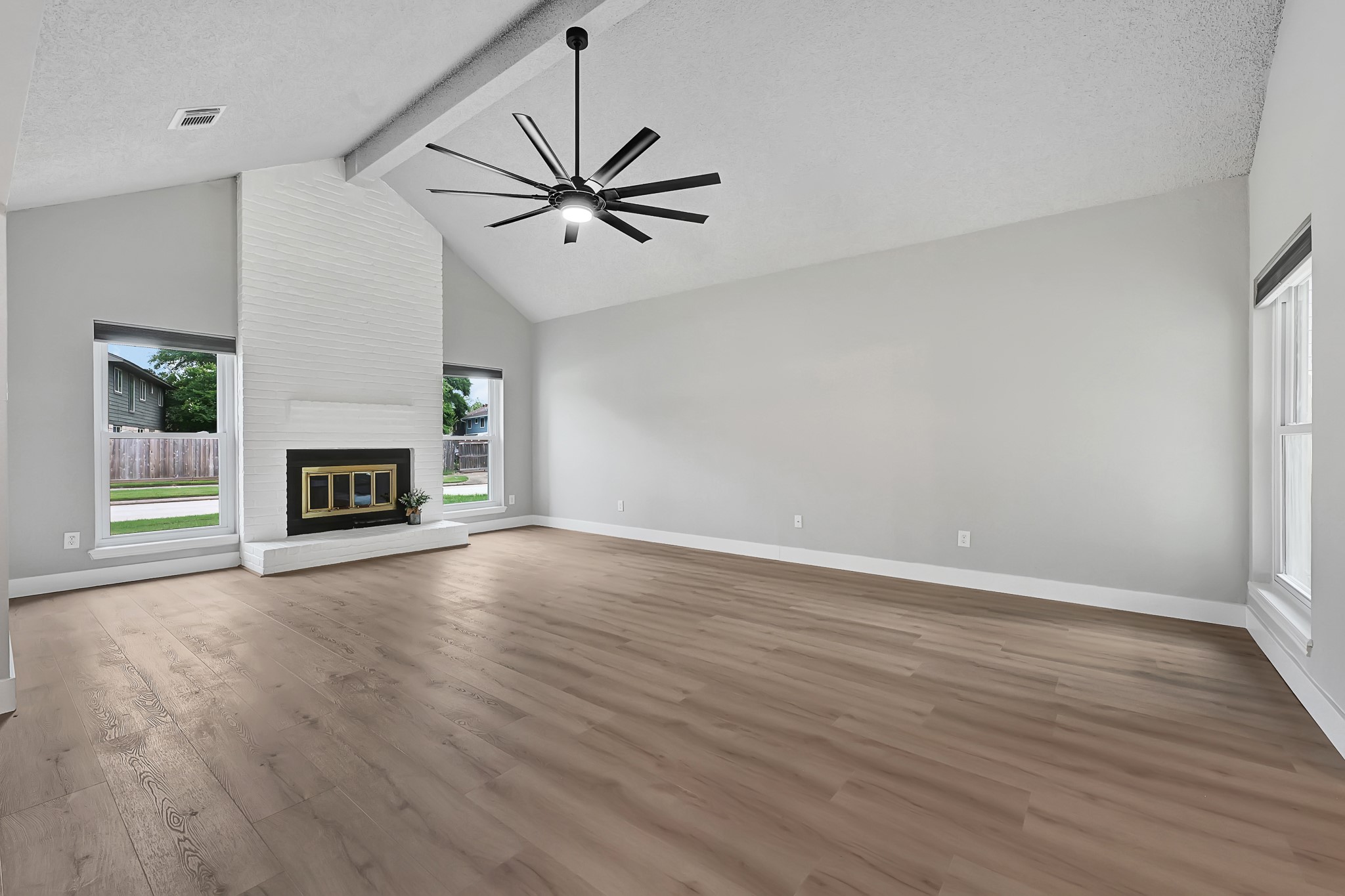 21211 Slippery Creek Lane Spring, TX 77388 - Photo 9 of 29 a view of an empty room with wooden floor fireplace and a window
