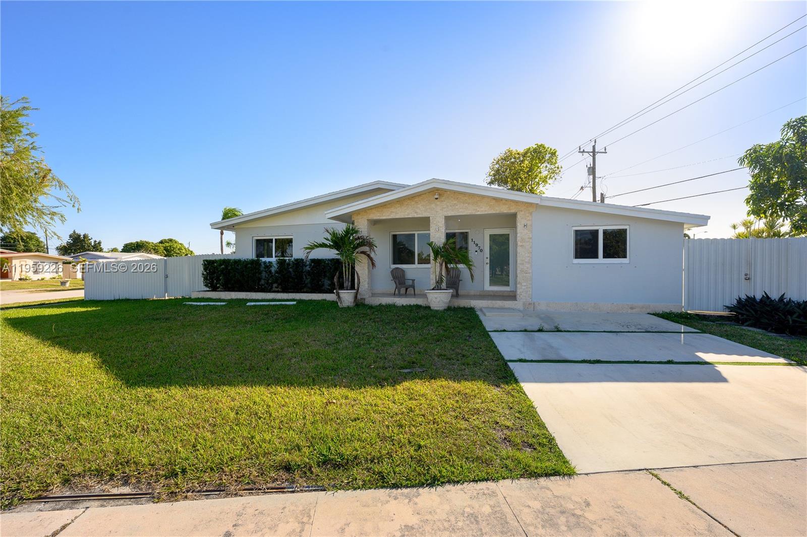 11970 Southwest 177th Terrace Miami, FL 33177 - Photo 1 of 47 a front view of a house with a yard