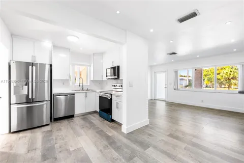 a kitchen with stainless steel appliances a refrigerator stove and microwave