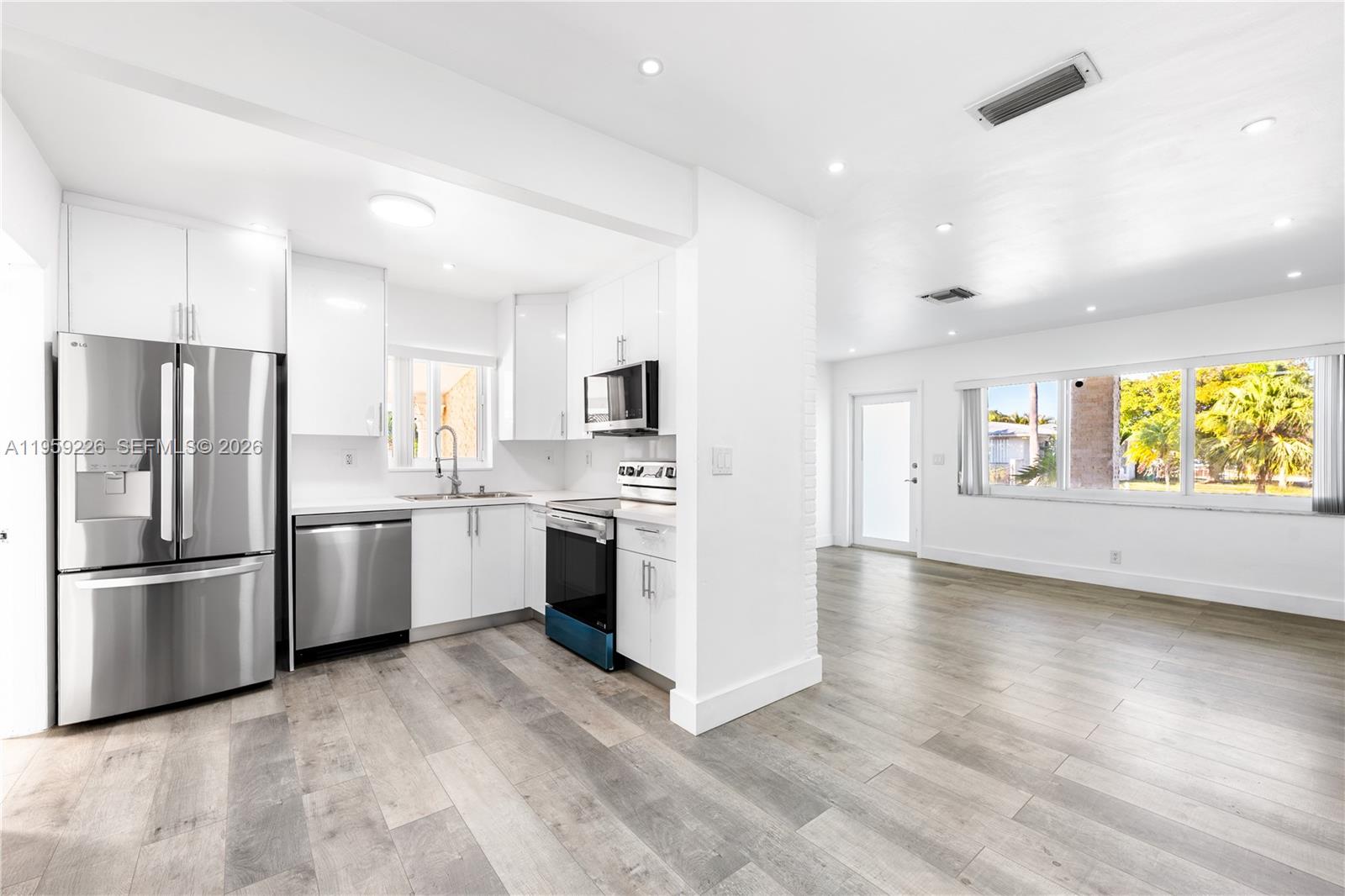 11970 Southwest 177th Terrace Miami, FL 33177 - Photo 11 of 47 a kitchen with a refrigerator and a stove top oven