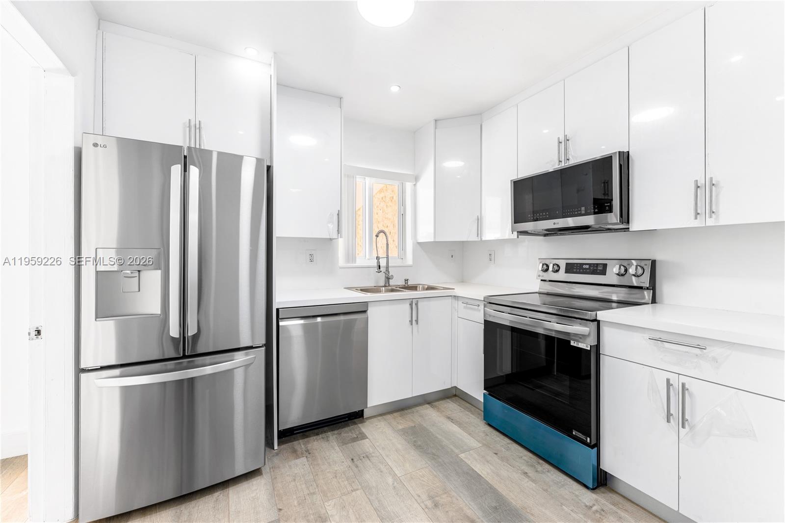 11970 Southwest 177th Terrace Miami, FL 33177 - Photo 12 of 47 a kitchen with stainless steel appliances a refrigerator stove and microwave