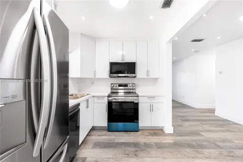 a kitchen with granite countertop a stove and a microwave