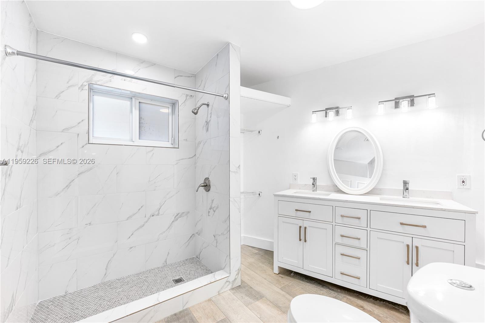 11970 Southwest 177th Terrace Miami, FL 33177 - Photo 19 of 47 a bathroom with a double vanity sink mirror and shower