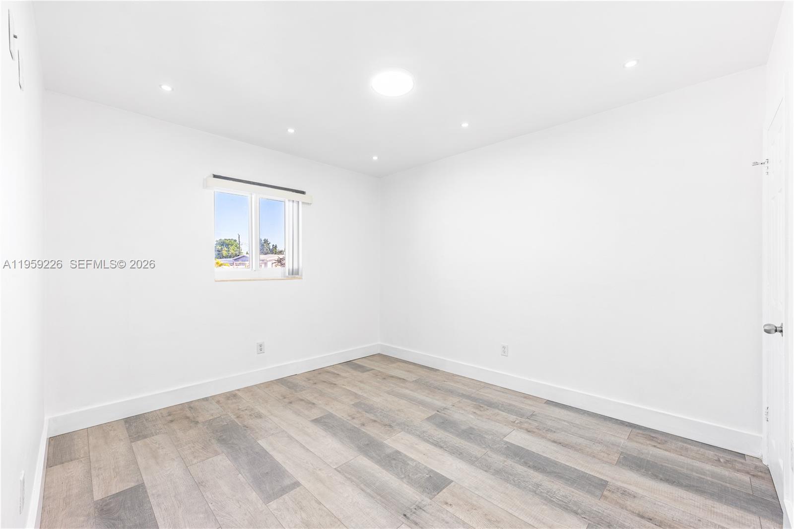 11970 Southwest 177th Terrace Miami, FL 33177 - Photo 24 of 47 a view of room with wooden floor and window