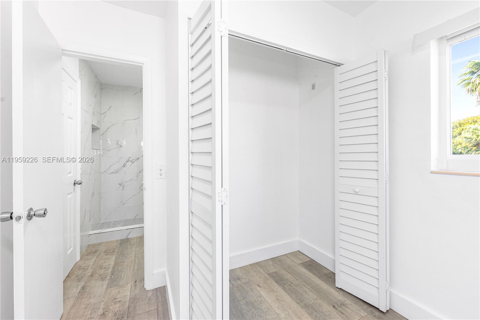 11970 Southwest 177th Terrace Miami, FL 33177 - Photo 26 of 47 a view of a hallway with wooden floor and closet area