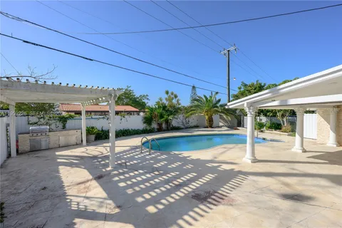 a view of swimming pool with outdoor seating and plants