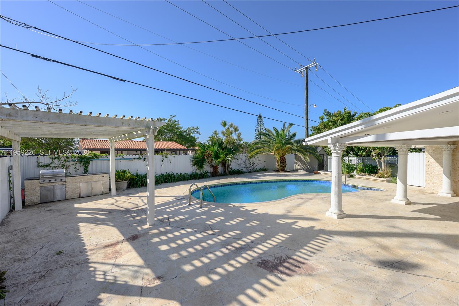 11970 Southwest 177th Terrace Miami, FL 33177 - Photo 31 of 47 a view of a swimming pool with a patio
