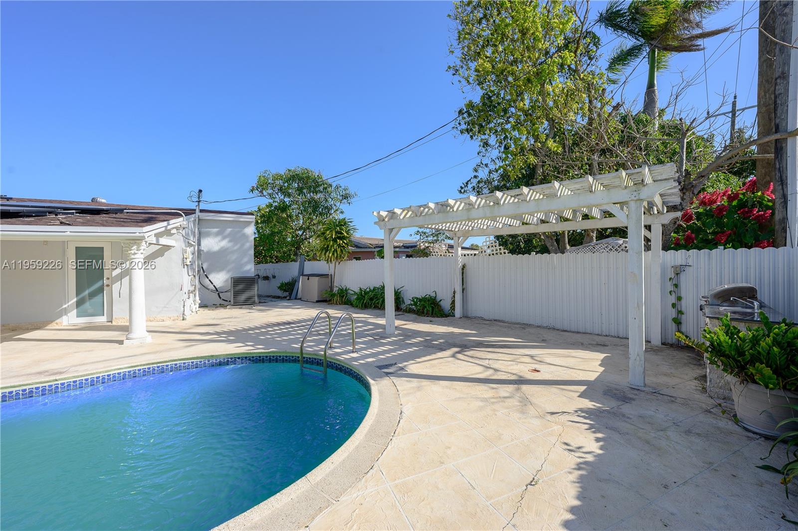 11970 Southwest 177th Terrace Miami, FL 33177 - Photo 33 of 47 a view of swimming pool with outdoor seating and plants