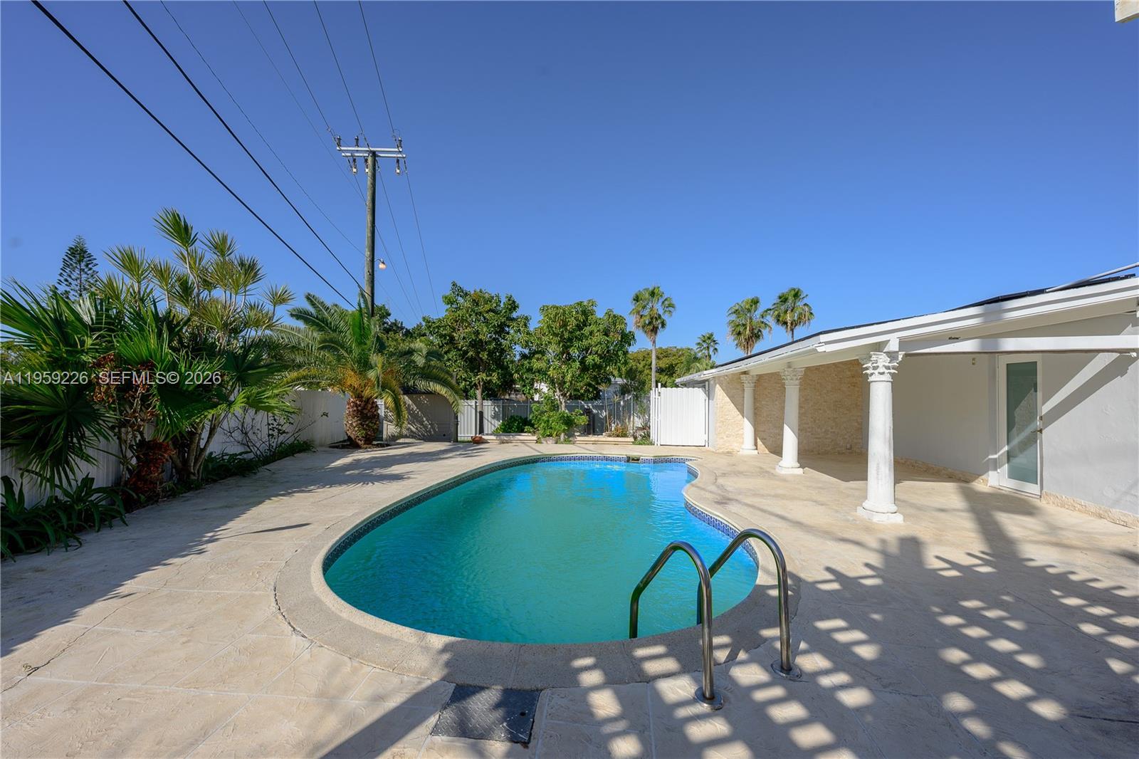 11970 Southwest 177th Terrace Miami, FL 33177 - Photo 34 of 47 a view of a swimming pool with a yard