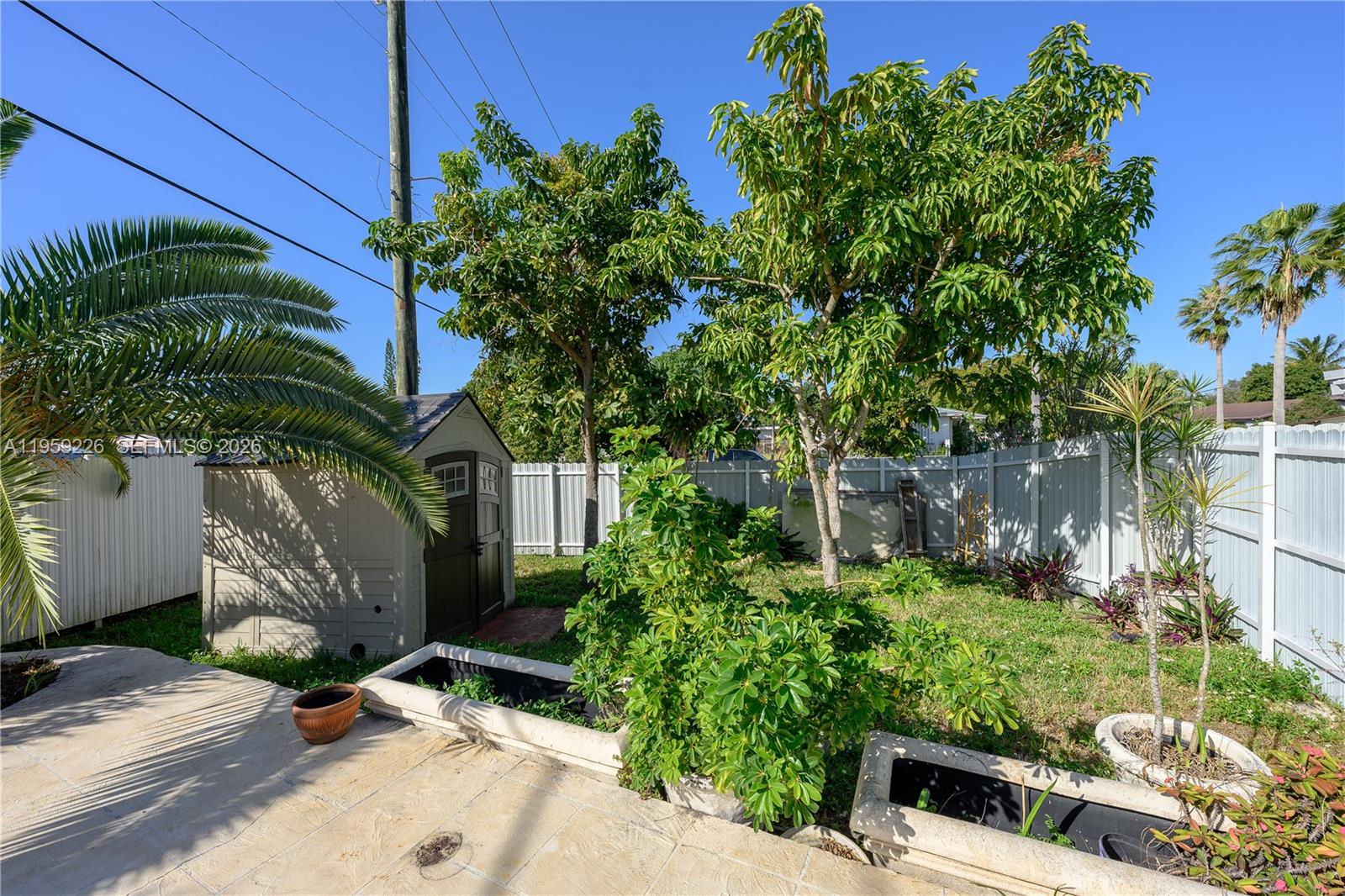11970 Southwest 177th Terrace Miami, FL 33177 - Photo 36 of 47 a backyard of a house with lots of green space