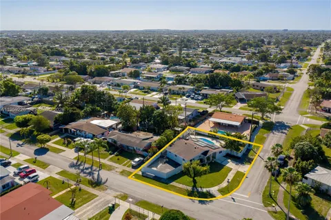 an aerial view of a house with a swimming pool