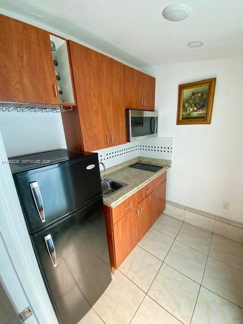 11970 Southwest 177th Terrace Miami, FL 33177 - Photo 46 of 47 a kitchen with stainless steel appliances granite countertop a stove a sink and a microwave