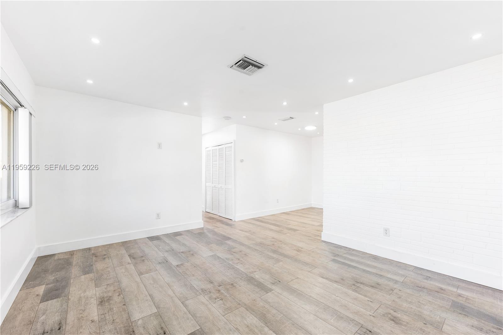 11970 Southwest 177th Terrace Miami, FL 33177 - Photo 9 of 47 an empty room with wooden floor and windows