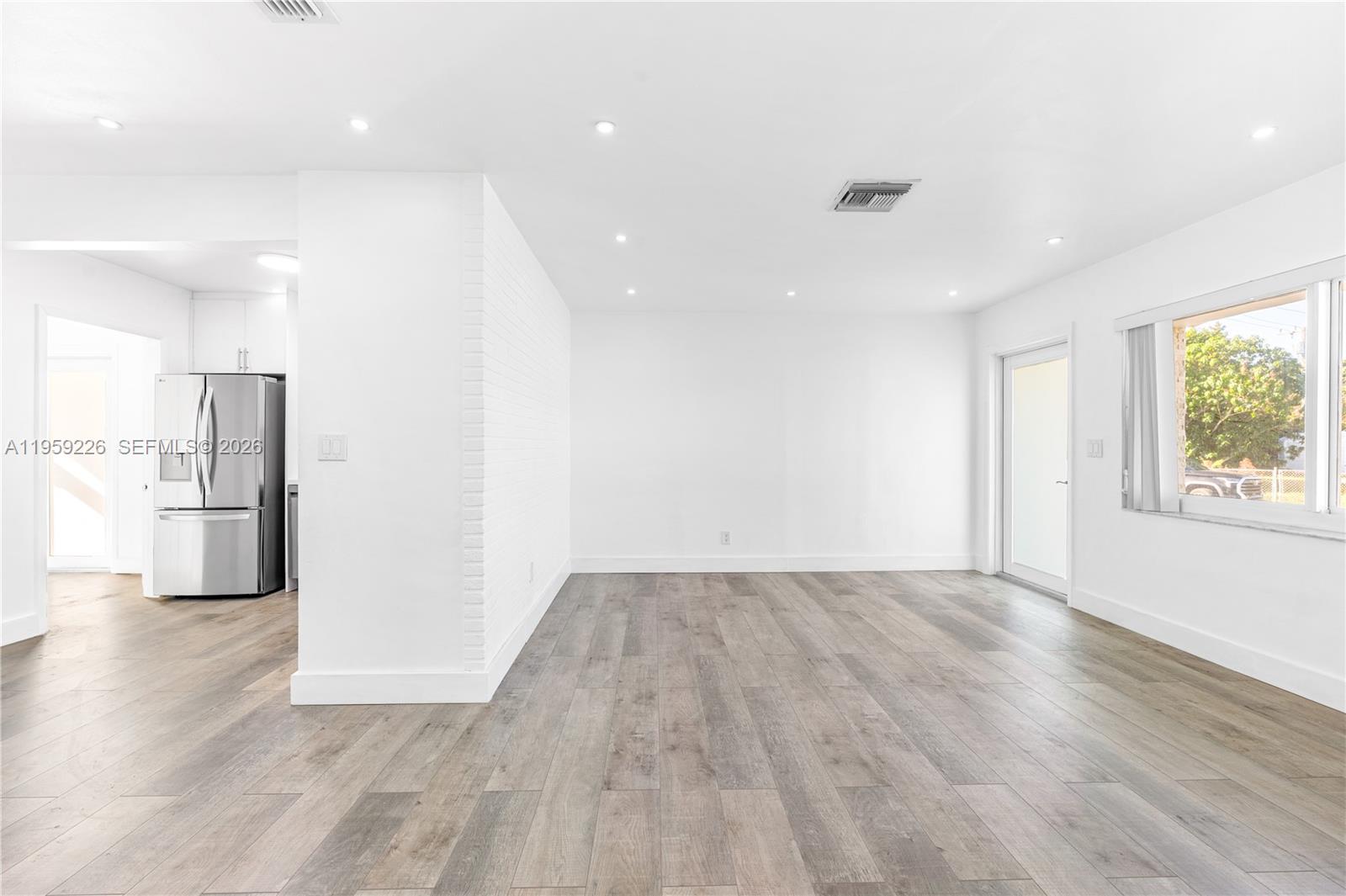 11970 Southwest 177th Terrace Miami, FL 33177 - Photo 10 of 47 a view of empty room with wooden floor and windows
