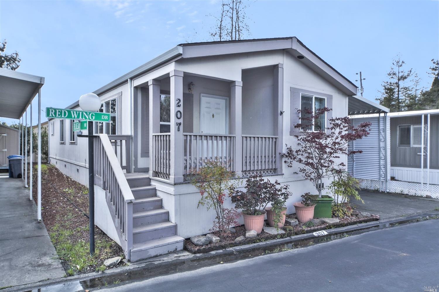207 Redwing Drive, Unit 207 Santa Rosa, CA 95409 - Photo 1 of 1 a front view of a house with garden