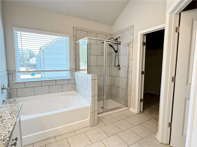 a bathroom with a bathtub and a shower