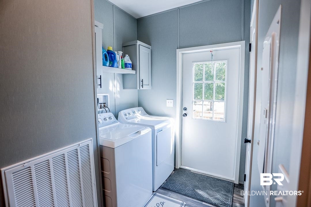 19180 Horseshoe Circle Seminole, AL 36574 - Photo 17 of 38 Laundry area with cabinet space and washer and clothes dryer