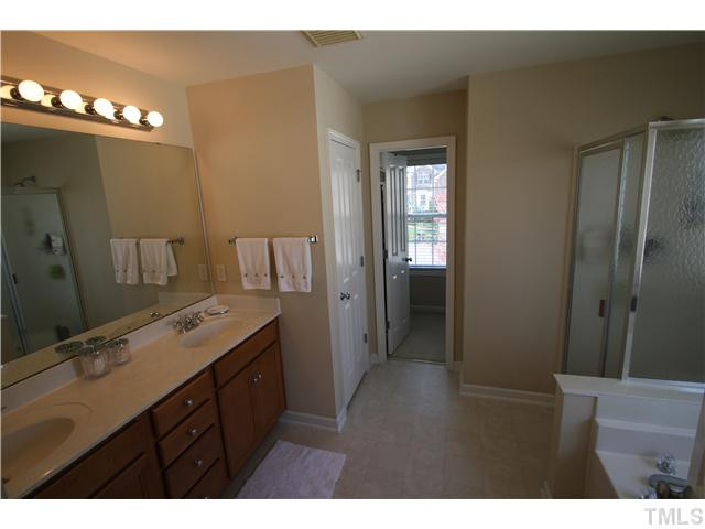 8413 Dunnington Circle Raleigh, NC 27613 - Photo 11 of 21 Walk right into your closet and finish dressing after your shower. Block glass window above garden tub lets light in without compromising privacy. Master Bath/Spa