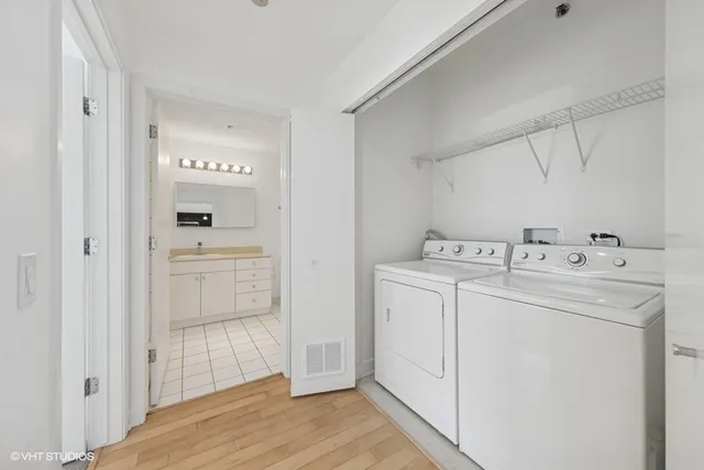 a utility room with cabinets washer and dryer