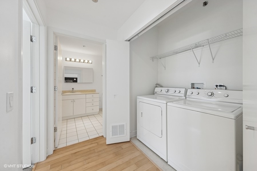 8 East Randolph Street, Unit 3007 Chicago, IL 60601 - Photo 11 of 15 a utility room with cabinets washer and dryer
