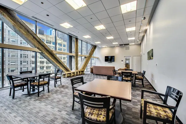 a dining room with wooden floor a table and chairs
