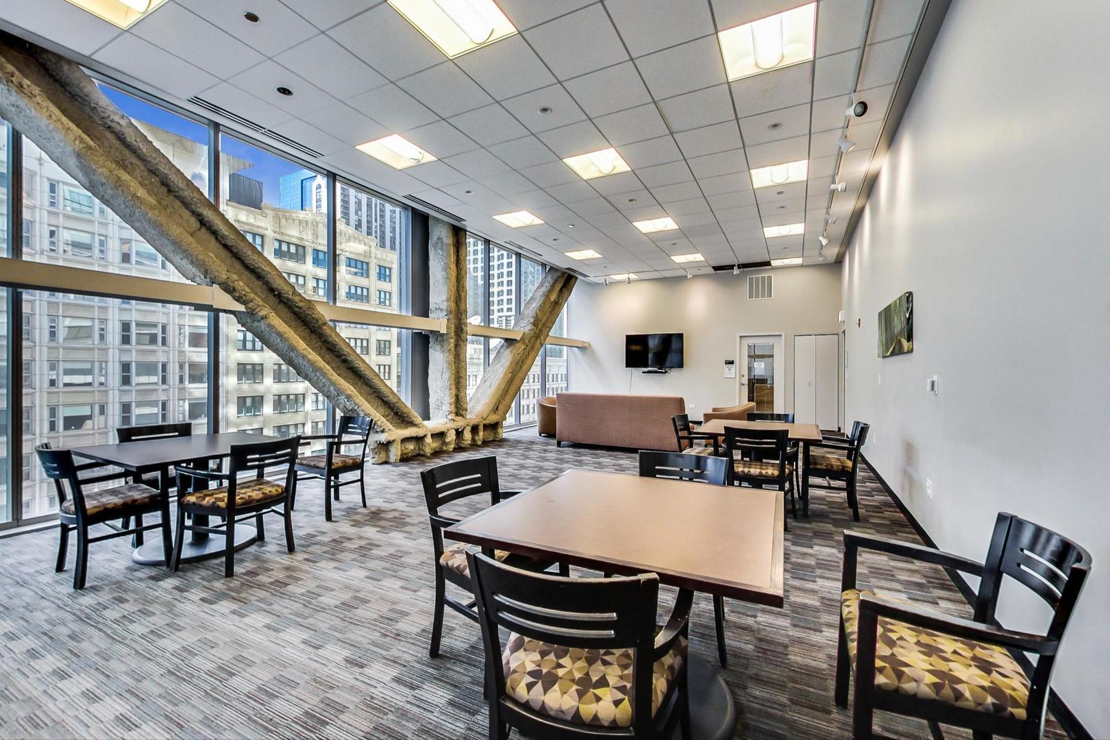 8 East Randolph Street, Unit 3007 Chicago, IL 60601 - Photo 15 of 15 a dining room with wooden floor a table and chairs