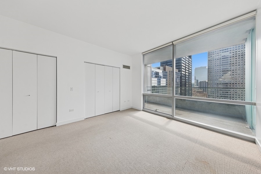8 East Randolph Street, Unit 3007 Chicago, IL 60601 - Photo 9 of 15 a view of an empty room with sliding door