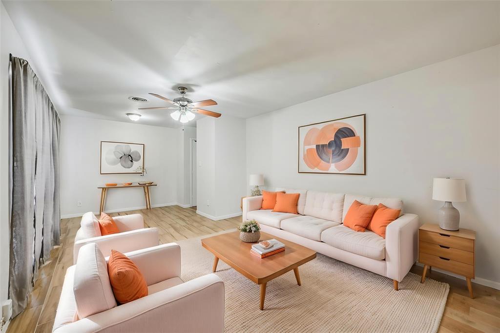 1905 South Cooper Street Arlington, TX 76010 - Photo 2 of 15 Bright living space featuring light wood-finish flooring and a neutral color palette