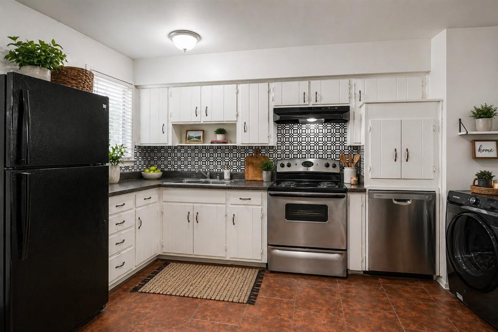 1905 South Cooper Street Arlington, TX 76010 - Photo 9 of 15 Kitchen featuring white cabinetry, dark countertops, and a patterned tile backsplash