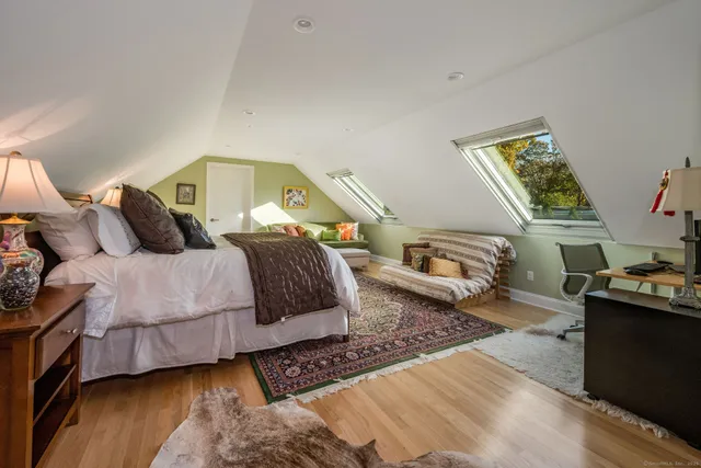 a bathroom with a granite countertop toilet sink and mirror