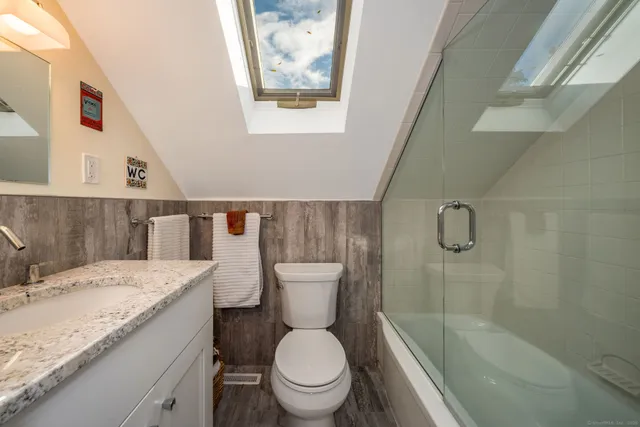 a large bedroom with a bed and a couch