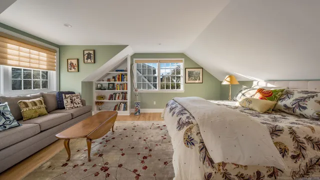 a backyard of a house with table and chairs under an umbrella