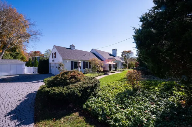a front view of a house with a yard table and chairs