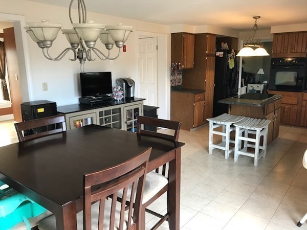 720 East Hill Road East Oakham, MA 01068 - Photo 8 of 25 a kitchen with stainless steel appliances granite countertop a table chairs and a refrigerator