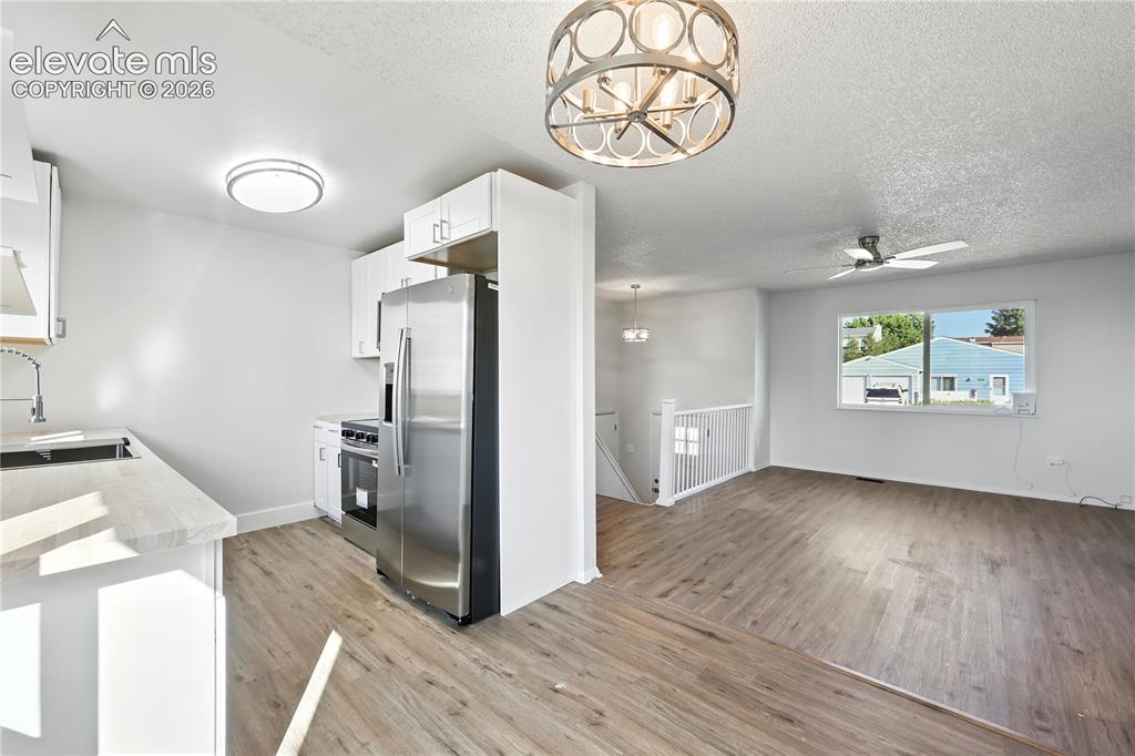 7033 Sequoyah Way Colorado Springs, CO 80915 - Photo 9 of 20 a view of a hallway with wooden floor