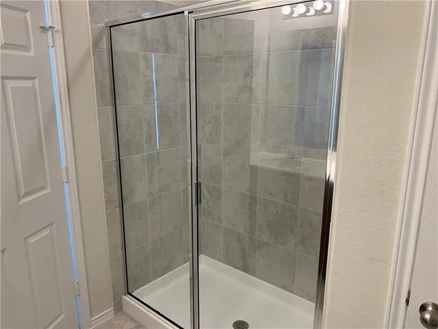 a bathroom with a glass shower door