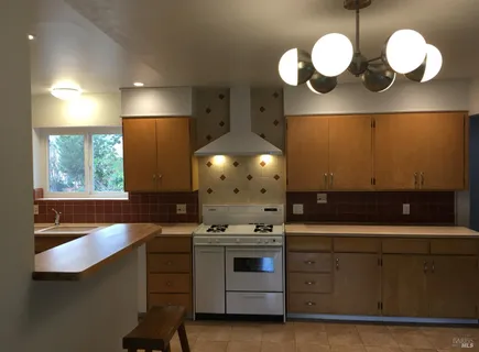 a kitchen with a sink cabinets and window