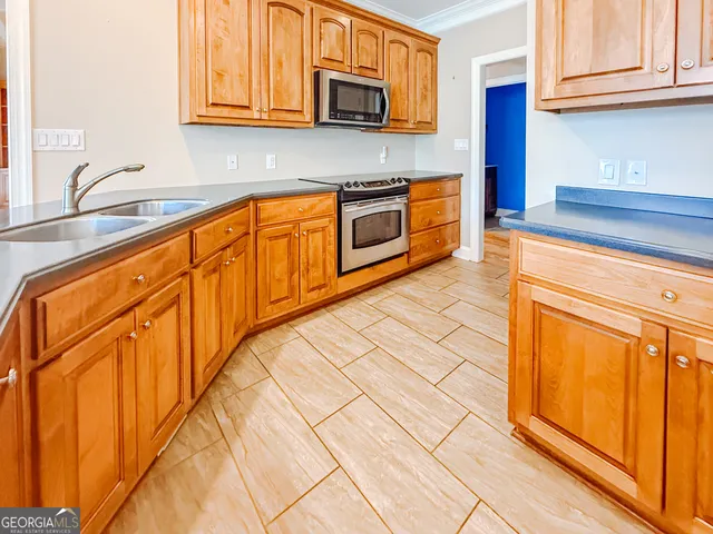 a kitchen with stainless steel appliances granite countertop a sink and cabinets