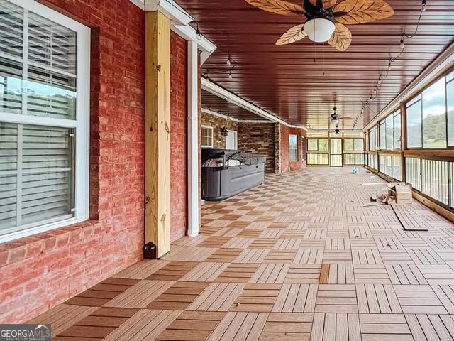 a view of a house with pool and chairs